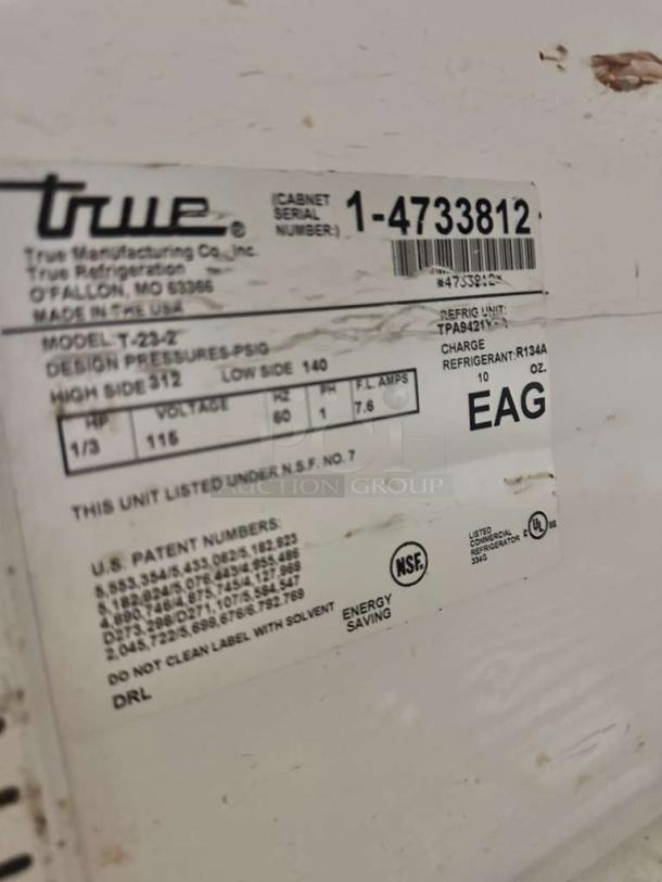 Label on True T-23-2 commercial refrigerator. Shows model, serial number 1-4733812, NSF certification, and 115V energy info.