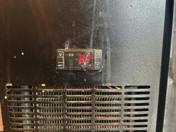 Migali BB60-N12 back bar refrigerator in like-new condition, digital display showing "P1," black exterior, tested and working.