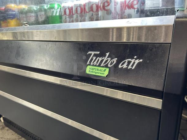 Turbo Air TOM-40B-SP-N 39 1/8" cooler, five levels, natural refrigerant logo, visible beverage cans, stainless steel trim.