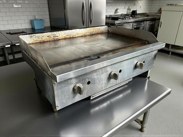 American Range ARSMG-36 countertop gas griddle in great condition, tested and working, with control knobs and metal finish.