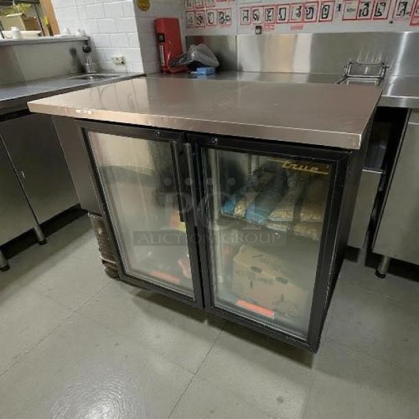 True Model TBB-24-48G LD bar refrigerator, 48 1/8", black, two swinging glass doors, stainless top, tested and working condition.