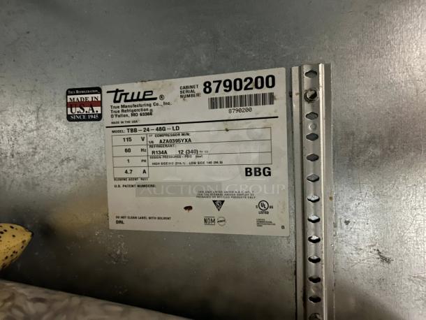Label on True Model TBB-24-48G LD bar refrigerator, shows specs like 115v, 60Hz, Made in USA, and refrigerant type R134A.