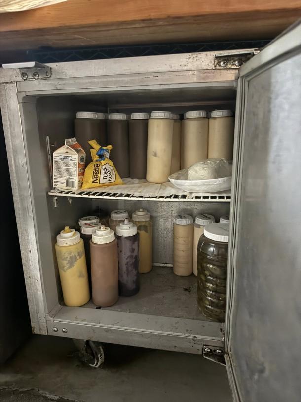 Continental UC48 undercounter refrigerator, 48", 13.4 cu ft, good condition, interior view with condiment bottles.