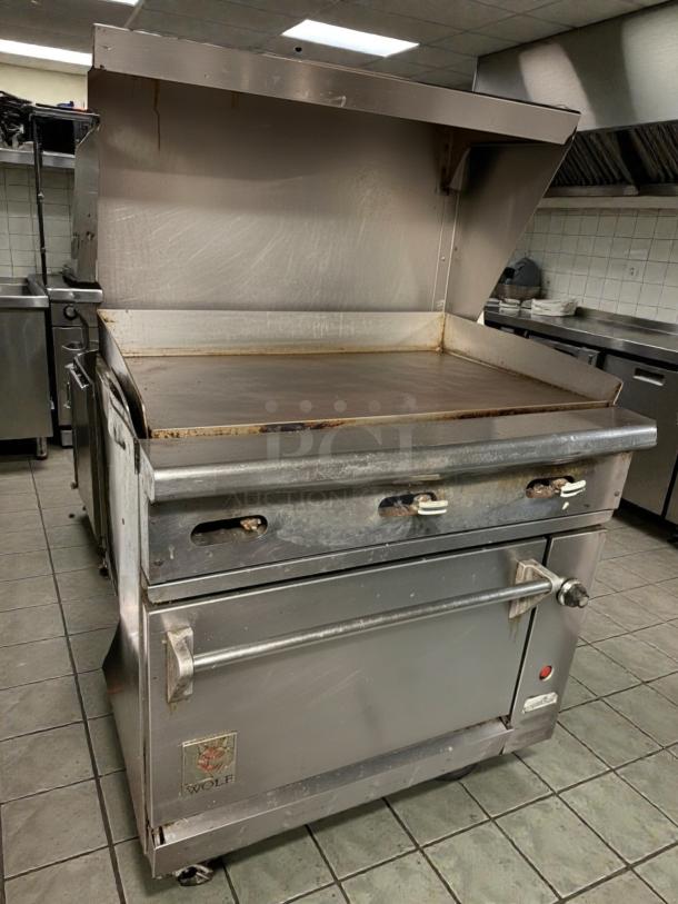 Wolf C36S-36G 36" gas range with full griddle and standard oven, tested and working, visible wear, sturdy build.