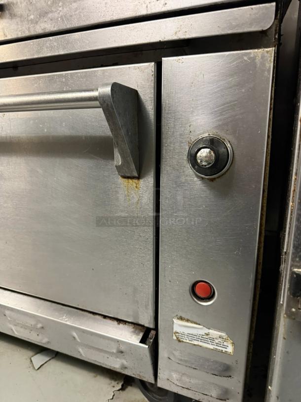Wolf C36S-36G 36" gas range with griddle and oven. Stainless steel. Tested, working. Some wear visible.