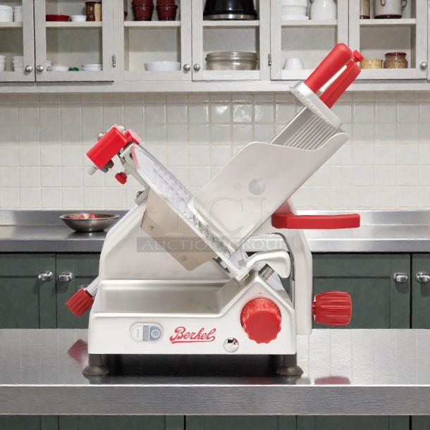 Berkel B12-SLC 12" manual slicer, angled gravity feed, 1/2 HP, excellent condition, tested and working, red knobs.