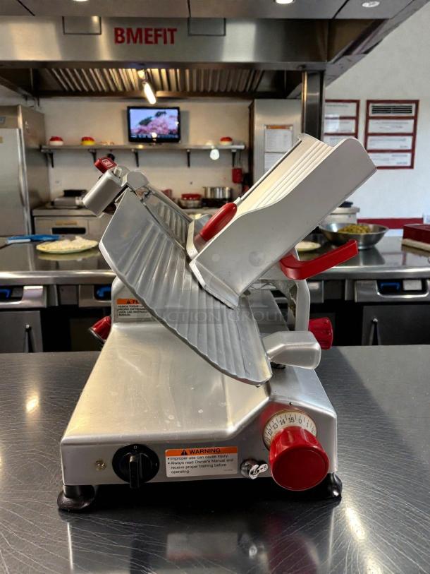 Berkel B12-SLC 12" slicer in fantastic condition, tested and working, with red controls and visible safety warnings.