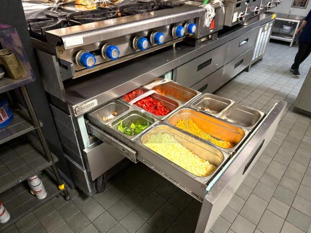 Delfield F2996CP refrigerated chef base, 96", 6-drawer unit, tested and working, stainless steel finish, with food pans visible.