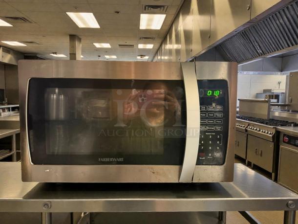 Farberware Professional 1.3 cu ft 1000-Watt Microwave Oven, stainless steel finish, tested and working, digital display.