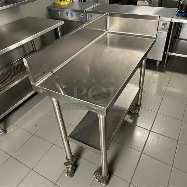 Omniteam 17" stainless steel worktop table with backsplash, casters, and lower shelf; excellent condition, ideal for heavy-duty use.