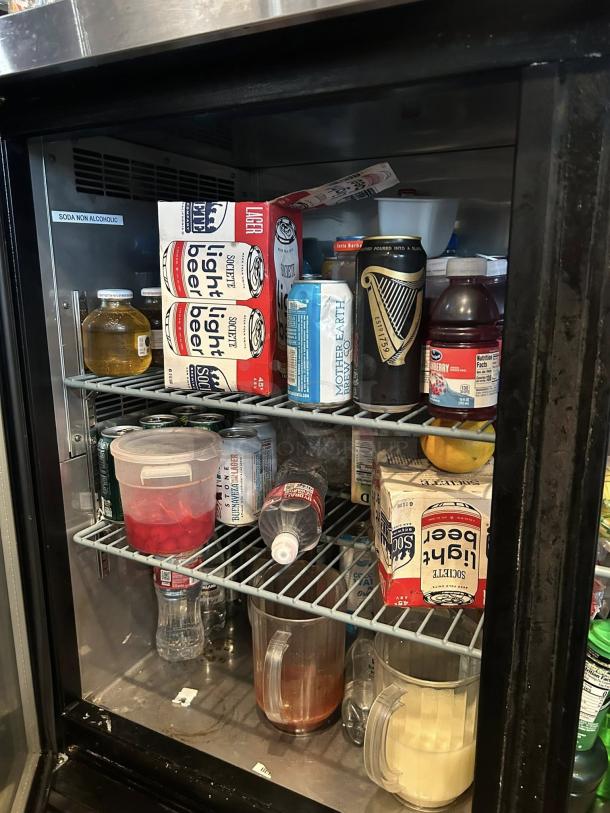 Dukers DBB60-H2 two-section glass door refrigerated back bar cooler, stocked with beverages, perfect condition.