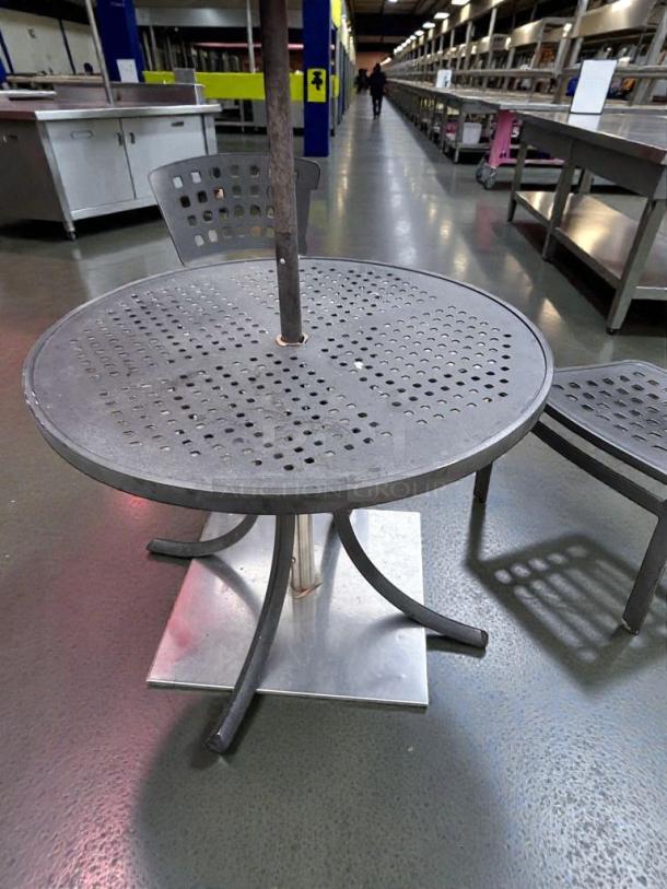 Round metal patio table in pristine condition, commercial-grade, umbrella-ready, fully inspected, ready for outdoor dining.