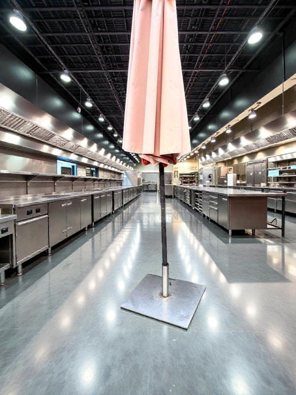 Refined condition commercial outdoor patio umbrella, heavy-duty canopy on a metal base. Fully inspected and ready to use.