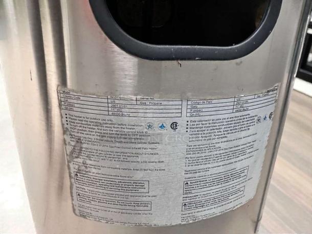 Stainless steel commercial patio heater with safety instructions label. Mushroom-top design. Tested and ready to use.