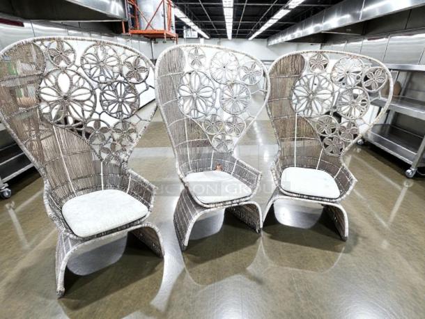 Set of 3 high-back wicker lounge chairs in pristine condition. Designer-grade outdoor furniture with intricate floral patterns.