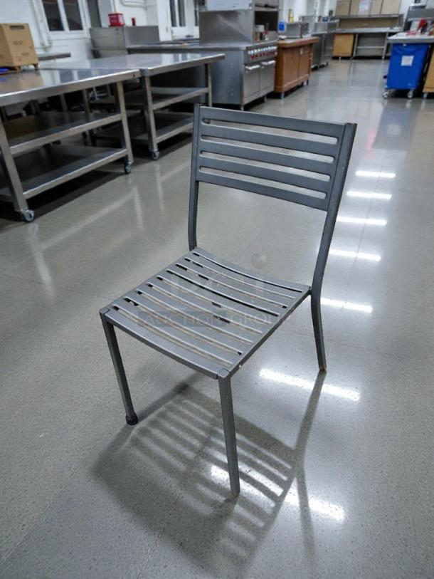 Commercial metal patio chair in immaculate condition, slatted design, fully inspected, ready to use.