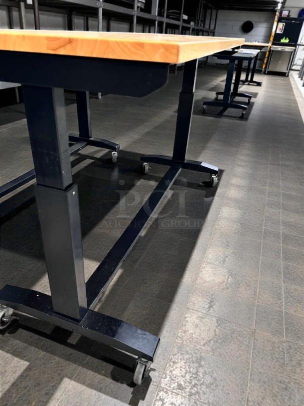 Four commercial solid wood prep tables on wheels, black metal frame, heavy-duty, inspected, outstanding condition.