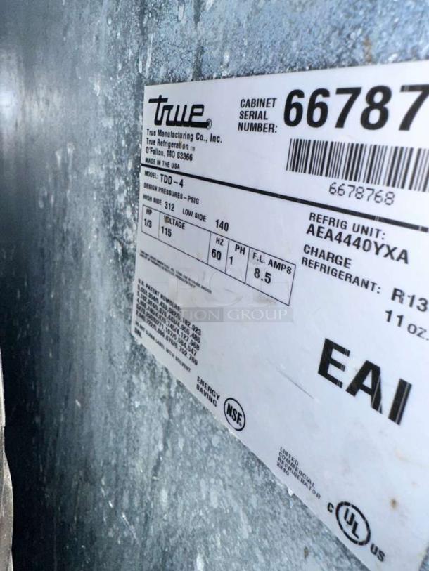 True TDD-4 beer dispenser label showing model details, 115V, serial number 66787, energy-saving, UL listed.