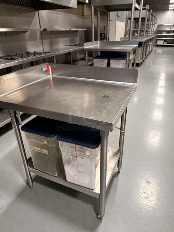 Commercial-grade stainless steel work table with backsplash in pristine condition, fully cleaned, ready for use.