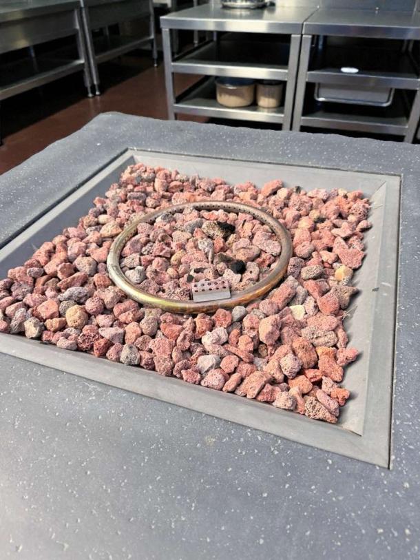 Pristine outdoor gas fire pit table, fully tested, dark finish, lava rocks, excellent condition, perfect for patio settings.