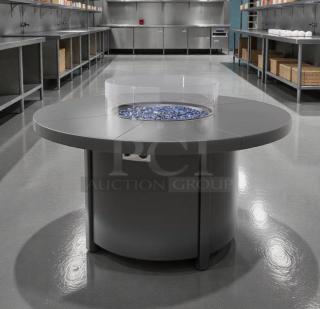 Round gas fire pit table in pristine condition, suitable for natural gas or propane. Brand: Outdoor Living/Commercial Patio.