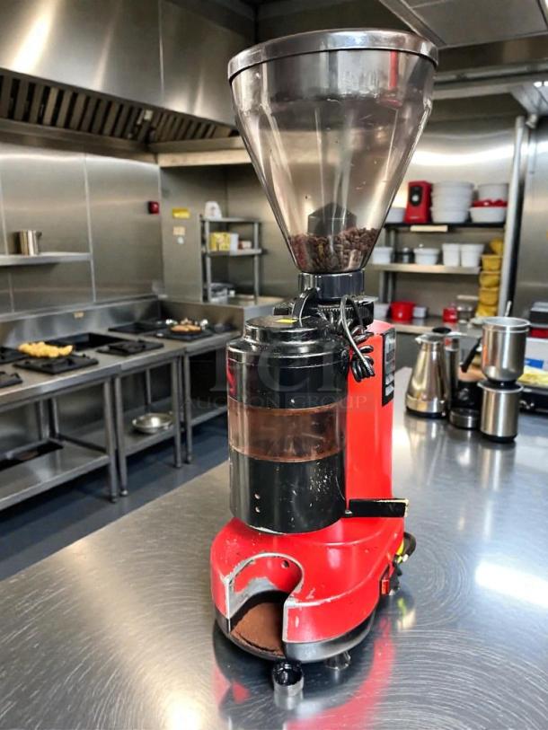 Premium condition commercial coffee grinder, 120V, red, in stainless steel kitchen. Fully tested and working.