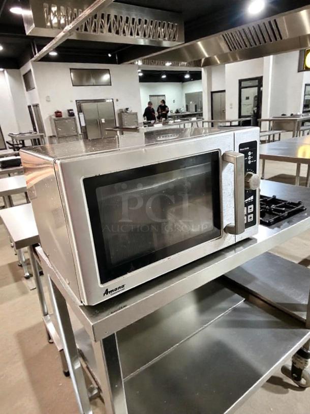 Prime condition Amana RCS10DSE commercial microwave oven, 120V, fully tested, sleek design, on a stainless steel cart.