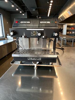 Pristine Astra Commercial Espresso Machine in black, two group heads, fully tested, 220–240V, prominent Astra branding.