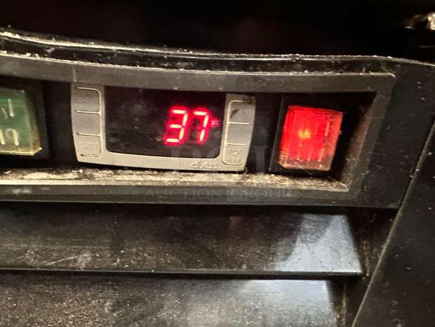 Control panel of Supera G1M-16-B-1 refrigerator displaying "37°F" on digital screen, red indicator light active, in pristine condition.