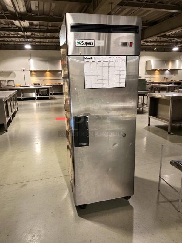 Pristine Supera FIR-1 commercial upright freezer, 115V, fully tested, stainless steel, with label and monthly calendar displayed.