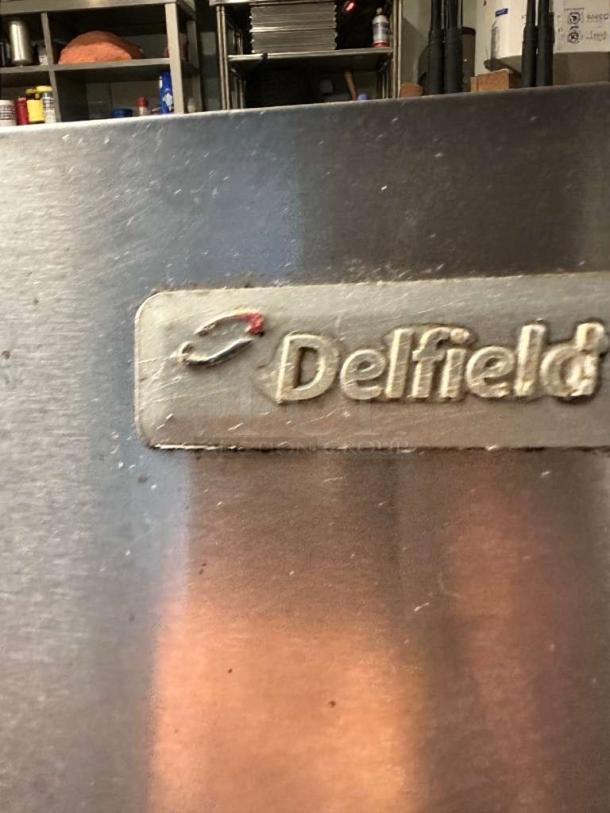 Delfield 6000XL four-door reach-in commercial freezer, stainless steel, logo visible, in outstanding condition.