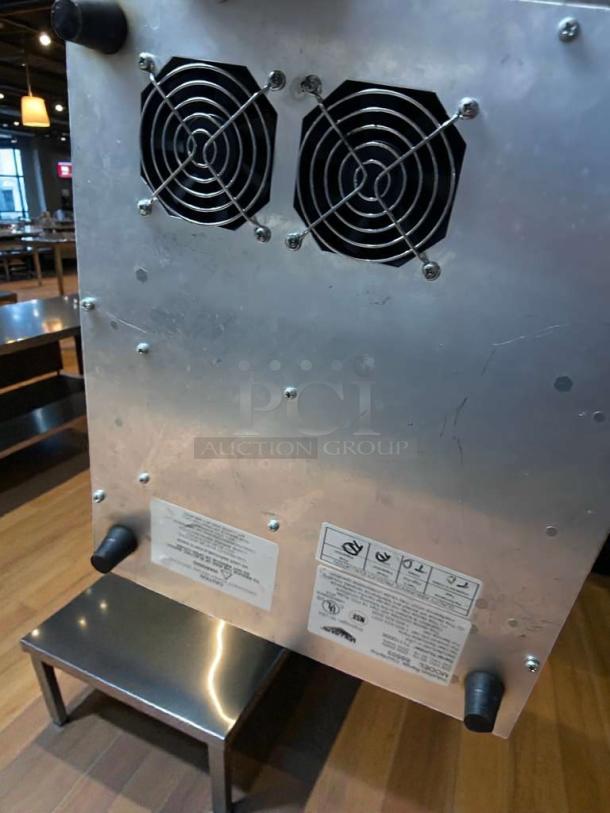 Vollrath 69503 countertop induction range, 208/240V, pristine condition, dual fan vents, visible labels with model and voltage details.