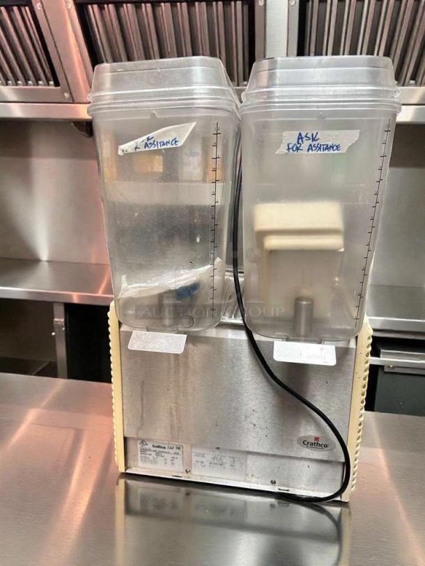 Crathco D25-4 dual frozen beverage dispenser, excellent condition, 115V, clearly labeled containers, fully tested and working.