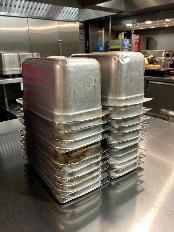 Stack of Carlisle DuraPan™ 1/3 size stainless steel hotel pans, model 607136, 6" deep, in excellent condition.