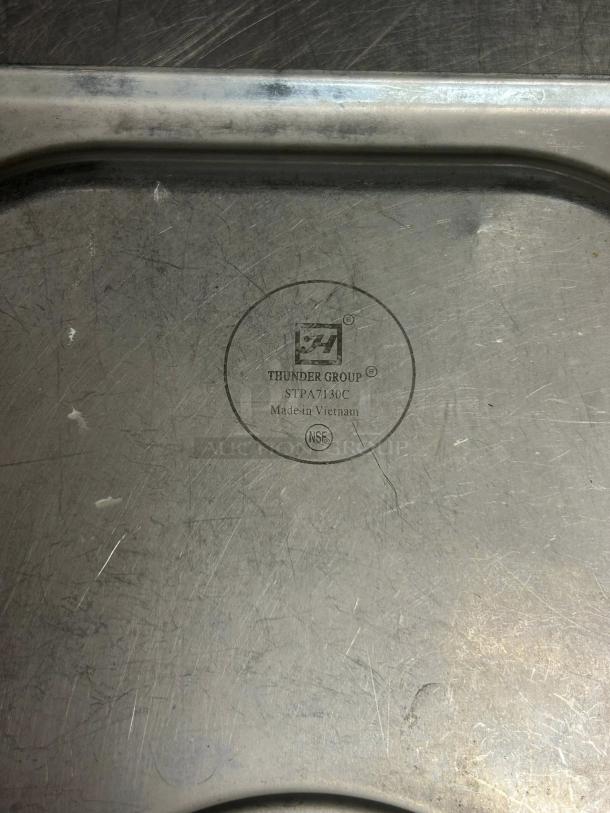 Thunder Group stainless steel 1/3 size slotted steam table pan cover, model STPA5130CS, in great condition. Made in Vietnam.