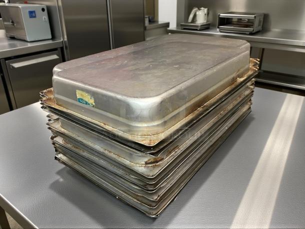 Stack of Carlisle 607002 DuraPan stainless steel hotel pans, full size, 2.5" deep, 24 gauge, light wear visible.