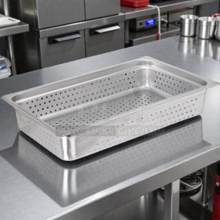 Carlisle DuraPan™ stainless steel perforated steam table pan, full-size, 4" deep, in perfect condition, on metal surface.