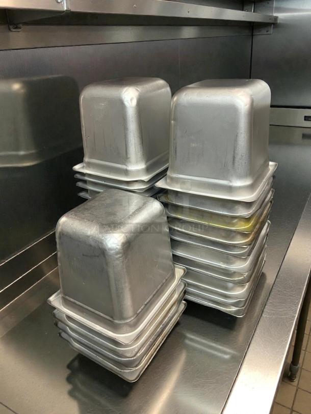 Winco SPJH-606 stainless steel steam table pans, 1/6 size, 6" deep. Heavy weight, excellent condition, stacked in a kitchen.