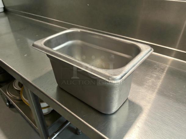Winco SPJH-904 solid steam table pan, 1/9 size, heavy weight, in amazing condition on a stainless steel surface.