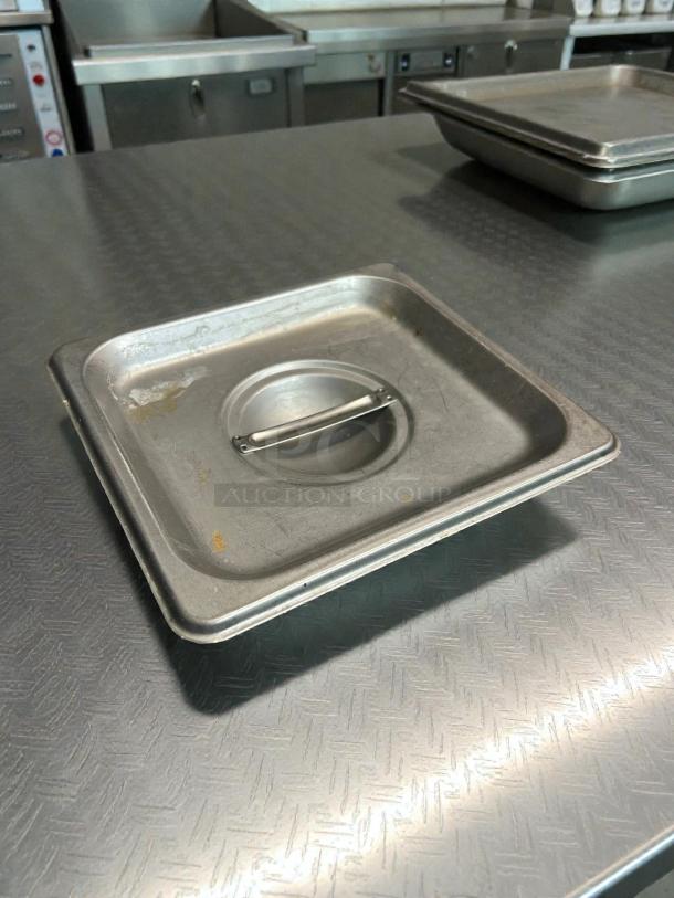 Winco SPCS 1/6 Size Stainless Steel Slotted Pan Cover, excellent condition, features center handle, durable design.