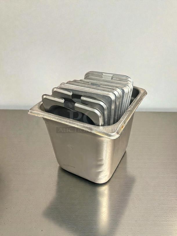 Choice 1/9 size stainless steel steam table pan covers, excellent condition, stacked in container. Durable and versatile.