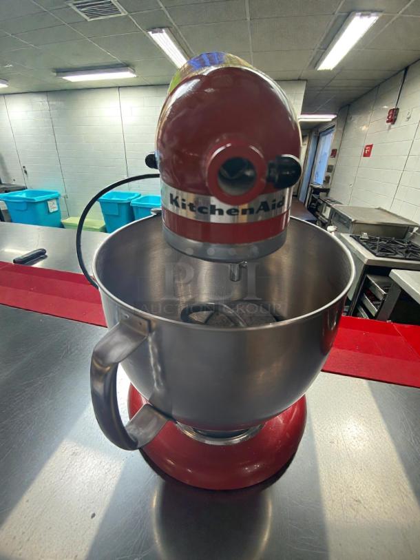KitchenAid Artisan 5-qt Stand Mixer in red, pristine condition, tested and working, visible label with brand, includes mixing bowl.