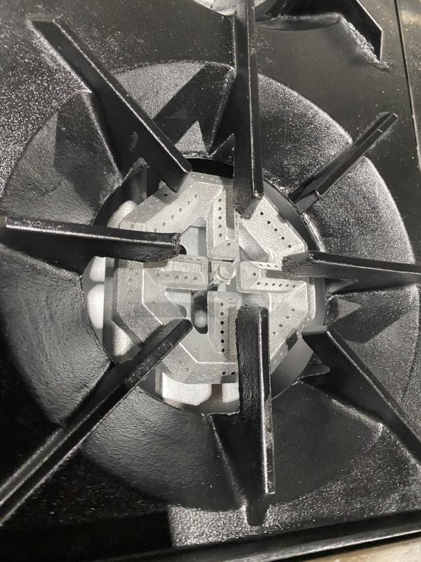 Close-up of a burner on the U.S. Range PS-10-2626RC commercial stainless steel 10-burner range. Natural gas powered.