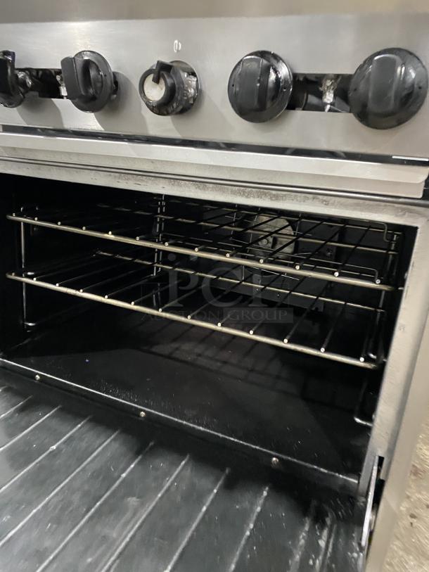 U.S. Range Performer Series 10 burner range/double oven, stainless steel, Model PS102626RC, on casters, with knobs shown.