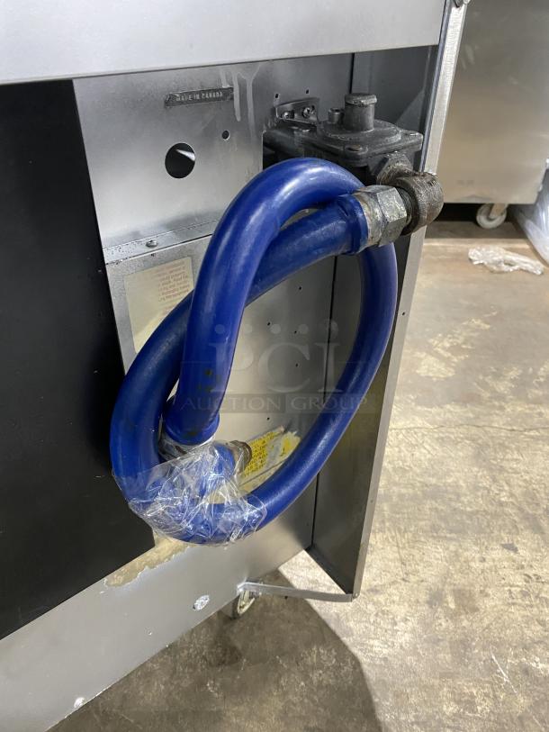 U.S. Range PS-10-2626RC commercial 10 burner range with double oven. Stainless steel, natural gas, on casters, blue gas hose attached.