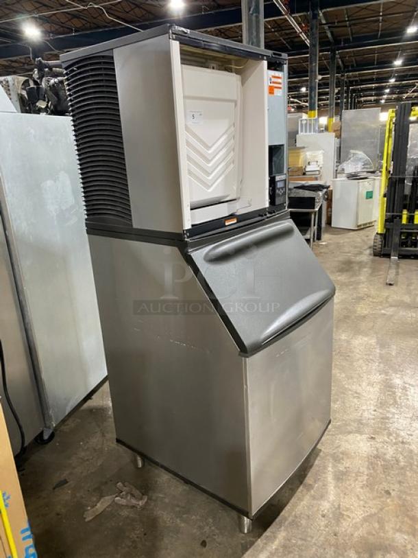 Manitowoc IR0850A-261 stainless steel ice machine, air-cooled, electric, 208-230V, on legs, industrial setting.