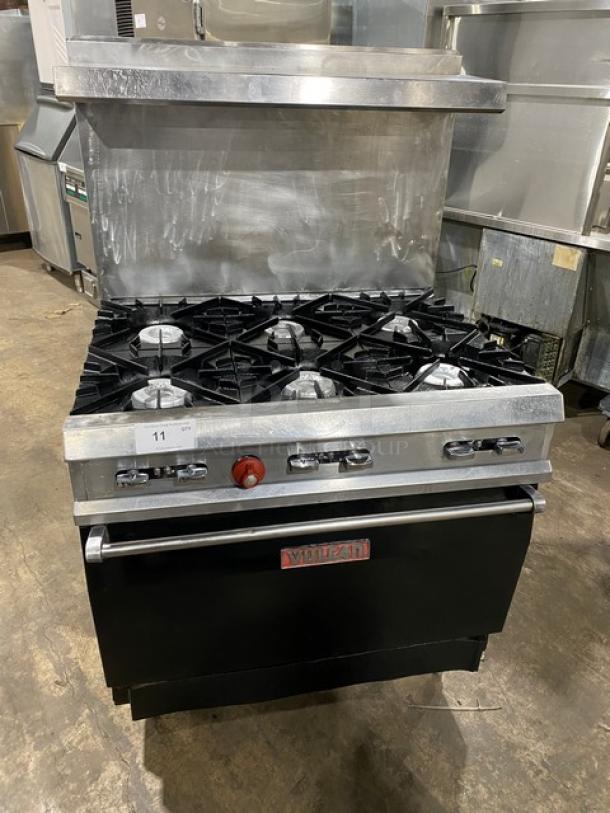 Vulcan commercial stainless steel gas 6-burner range/oven combo with backsplash, overhead salamander shelf, and wired oven rack.