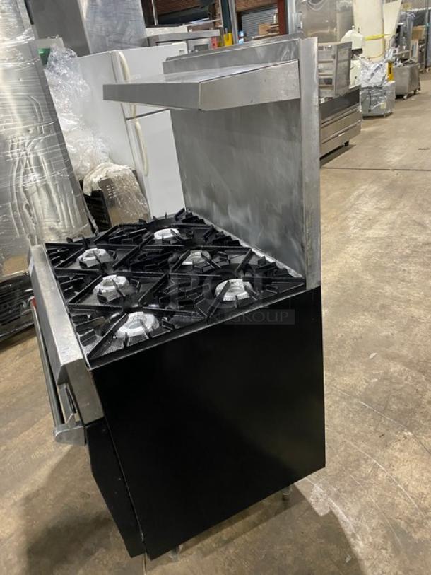 Vulcan stainless steel 6-burner gas range/oven combo with backsplash, overhead salamander shelf, and wired oven rack.