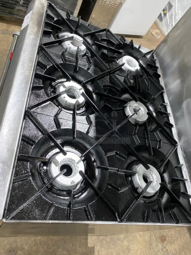 Vulcan stainless steel 6-burner gas range/oven combo with backsplash, overhead salamander shelf, and wired oven rack.