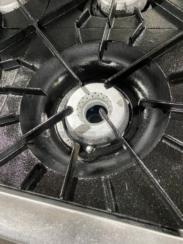 Vulcan stainless steel gas burner from 6-burner range/oven combo, featuring robust cast iron grates in excellent condition.